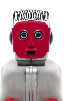 Vintage retro red face tin toy robot isolated on a white background.
