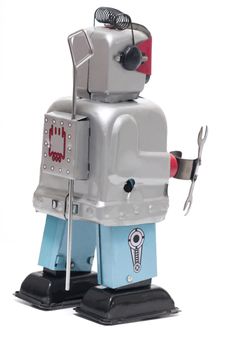 Vintage retro red face tin toy robot isolated on a white background.