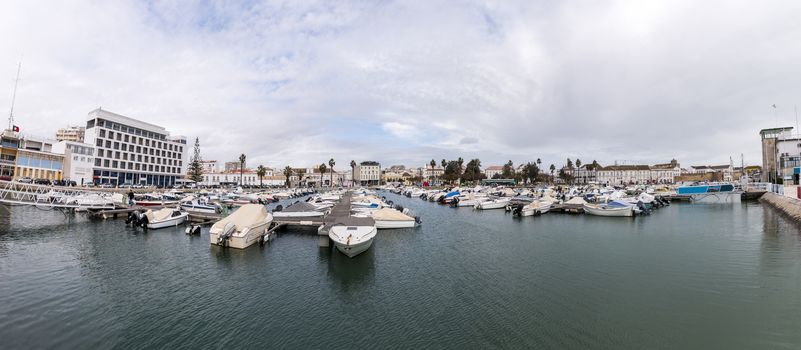 Wide view of Faro city docks with fishing and recreational boats.