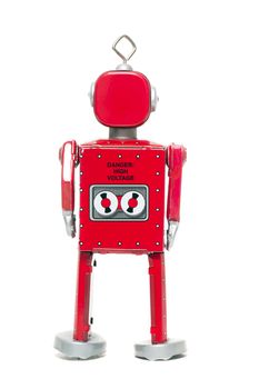 Vintage retro red tin toy robot isolated on a white background.