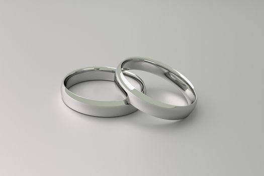 3D Illustraton of wedding rings on a light gray background.