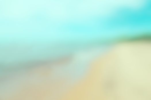 Defocused image of summer ocean, sky and beach. Lens blur effect.