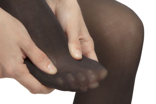 Close-up of female foot with pantyhose. Woman is rubbing her toes to relax pain.