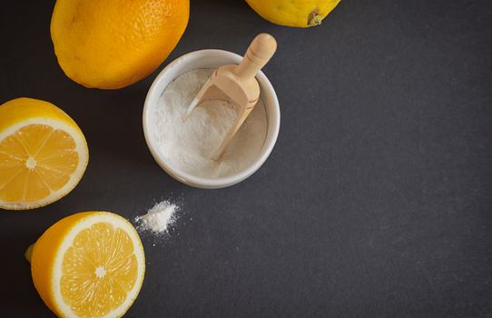 Lemon and baking soda on black background