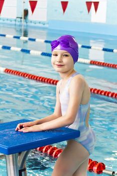 Portrait of smiling cute girl in swimming pool