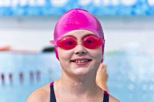 Portrait of smiling cute girl in swimming pool