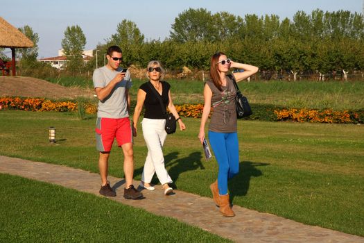 Young man and two women walking outside