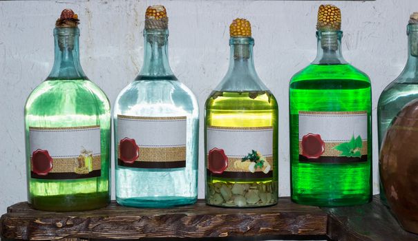 Ukrainian Russian home made moonshine vodka spirit on rural country style kitchen with village interior decoration accessories