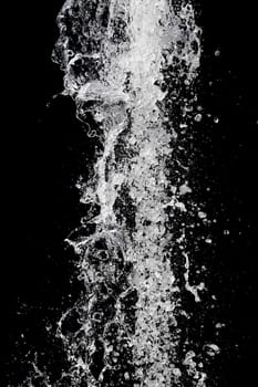 Splash of pouring water isolated over black background