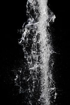 Splash of pouring water isolated over black background