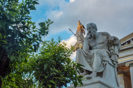 classical statue of Socrates from side with athena statue above