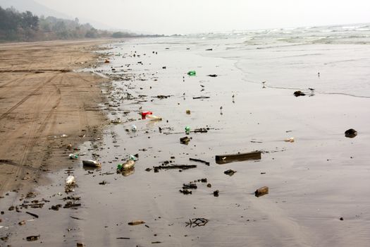 A beach which has thrown up all the tourist garbage during a high tide.