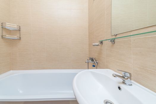 Close up of modern faucet and ceramic sink in bathroom