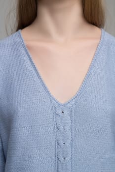 Close up of female model in knitted blue dress showing details