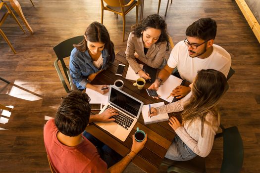 Group of friends studying together for finals