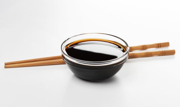 Soy sauce and chopsticks isolated on white background with clipping path