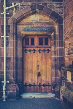 An Old Wooden Door At A College Of A Prestigious University Or School