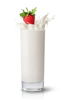 Strawberry falling into milk. Glass of milk isolated on white background. Splash of milk.