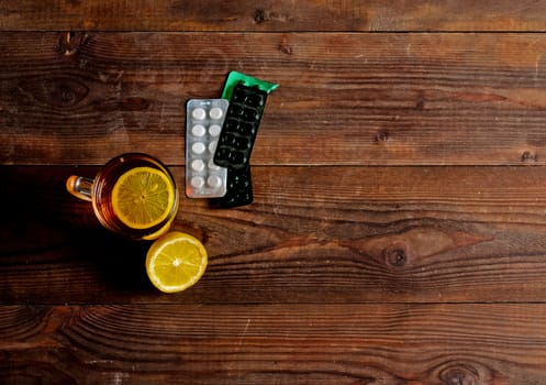 Seasonal flu: pills, tea with lemon. View from above