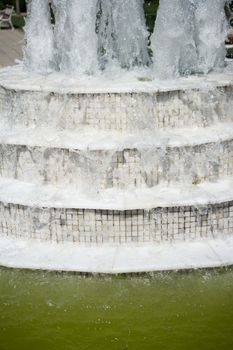 The fountains gushing sparkling water in a pool in a park