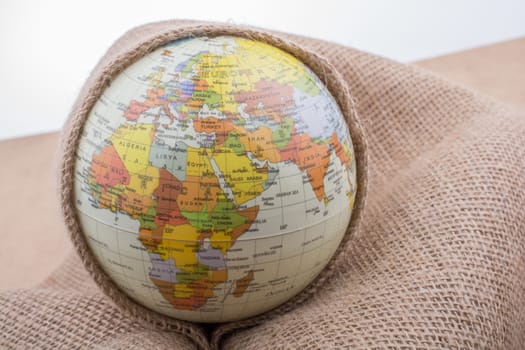 Linen canvas is wrapped around a model globe