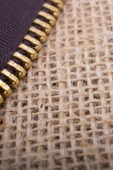 Closeup of a colorful  zipper on linen canvas