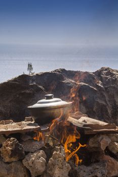 pot of fish soup being prepared on the fire, a warm quiet evening