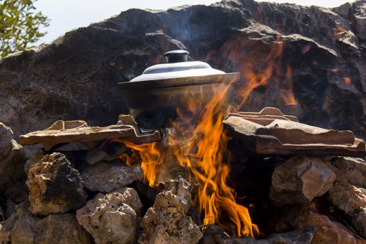 pot of fish soup being prepared on the fire, a warm quiet evening