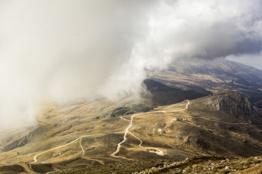 the serpentine road through sunlit mountains. Antalya