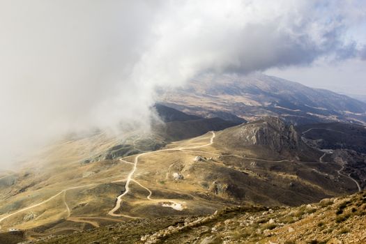 the serpentine road through sunlit mountains. Antalya