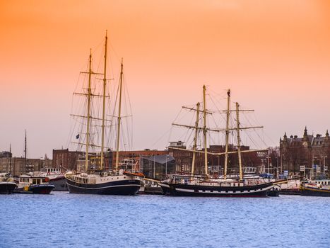 Old wooden ships in Amsterdam harbour, Netherlands.