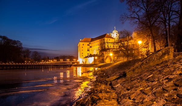 Illuminated Podebrady Castle at Labe River by night, Czech Republic.