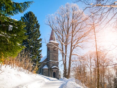 Stone church of Saint Peter and Paul in Tanvald on sunny winter day, Czech Republic.