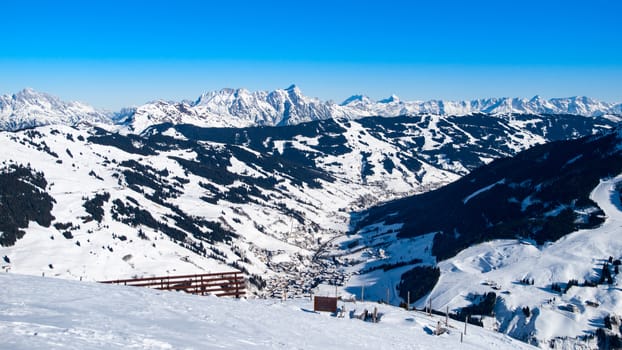 Panoramic view of winter mountains. Alpine peaks covered by snow.