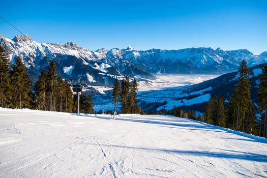 Panoramic view of winter mountains. Alpine peaks covered by snow.