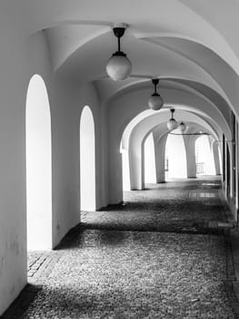Old historical arcade at Little Square in Old Town, Prague, Czech Republic. Black and white image.