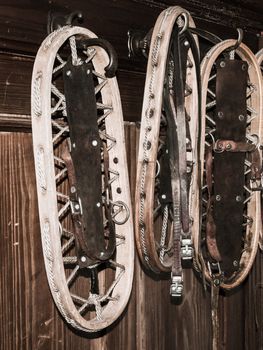 Vintage wooden snowshoes hanging on the wall in mountain cottage.