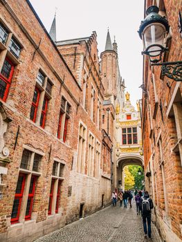 Bridge crossing between buildings over narrow Blinde-Ezelstraat, aka Blind donkey street, near Burg square, Bruges, Belgium.