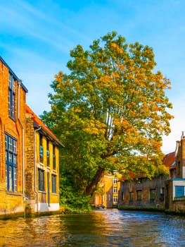 Old brick houses along water canals in Bruges, Belgium.