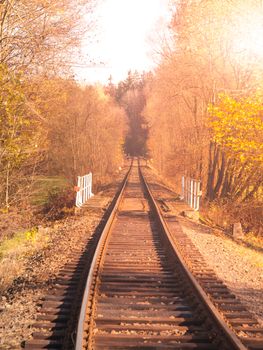 Rural railroad track on sunny autumn day.