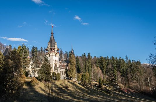 Peleș Castle near Sinaia and the Carpathian Mountains in a sunny day. Transylvania, Romania