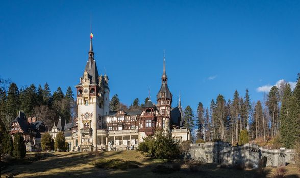 Peleș Castle near Sinaia and the Carpathian Mountains in a sunny day. Transylvania, Romania