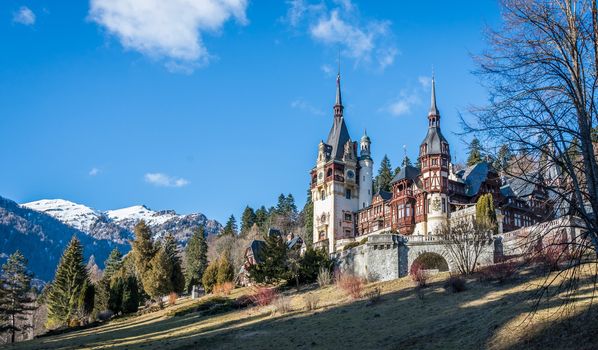 Peleș Castle near Sinaia and the Carpathian Mountains in a sunny day. Transylvania, Romania