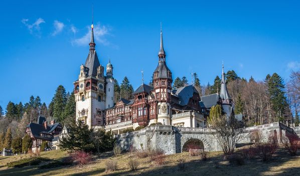 Peleș Castle near Sinaia and the Carpathian Mountains in a sunny day. Transylvania, Romania