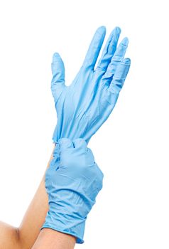 Doctor putting on protective blue gloves isolated on white background. Saved clipping path.