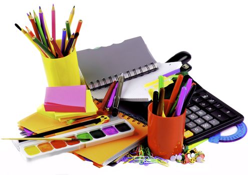 School Supplies Concept with Various Colorful Ballpoint Pens, Pencils, Felt Tip Pens, Pencil Sharpener, Watercolor Paints, Paper Clips, Calculator and Sticky Notes closeup on White background