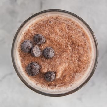 Chocolate smoothie on a white concrete background. Square cropping