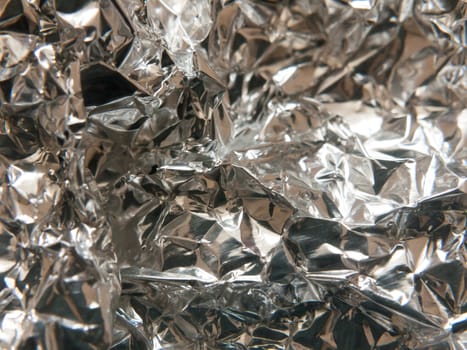 the texture and crinkled pattern of silver aluminium foil; Essex; UK