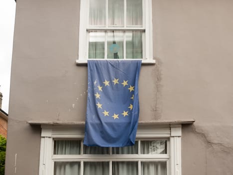 a european flag draped outside of a window; Essex; UK