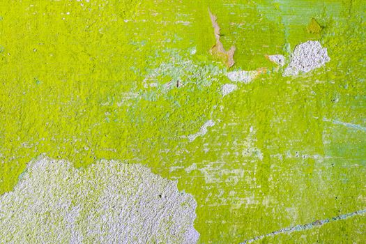 Green repair wall background with scratch and piece of paper. Rough housework wallpaper design backdrop. Color room interior decoration texture template